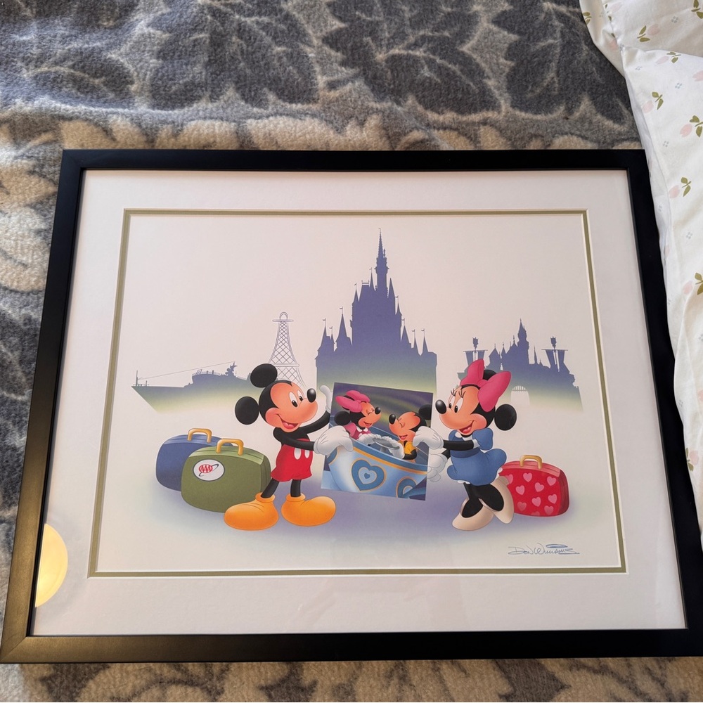 Framed photo of Mickey and Minnie Mouse.